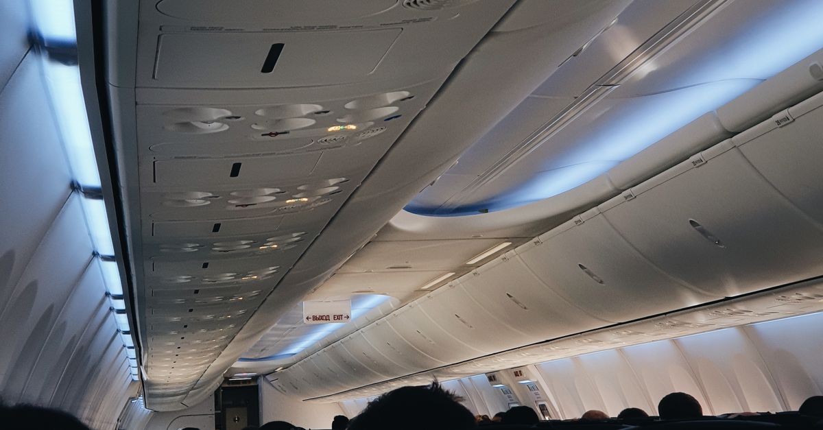Ceiling Panel In Aircraft Overhead Ceiling Panels and Blue Seats of an Aircraft · Free Stock Photo