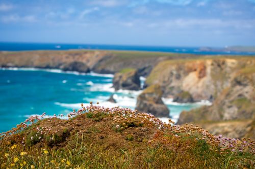 Free Explore the breathtaking view of coastal cliffs by a vibrant turquoise sea under clear skies. Stock Photo