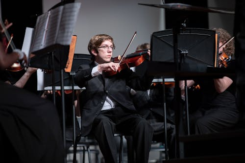 Man in Black Suit Playing Violin