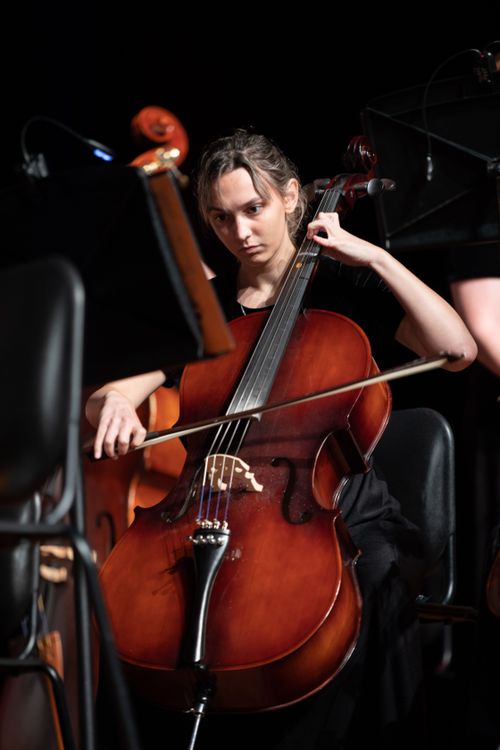 Free A serious female cellist performs passionately in a classical music concert. Stock Photo