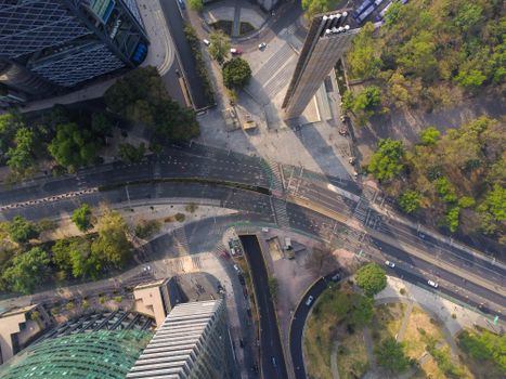 Drone shot capturing the urban architecture and street design enhanced by greenery.