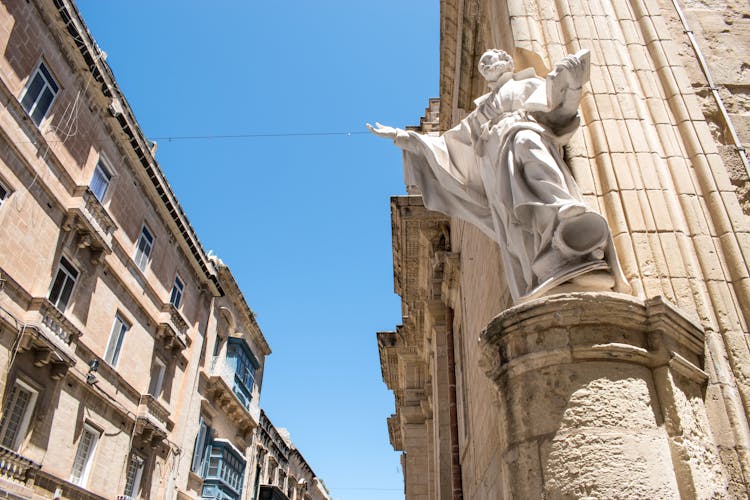 Scuplture On The Corner Of A Traditional Building In City 