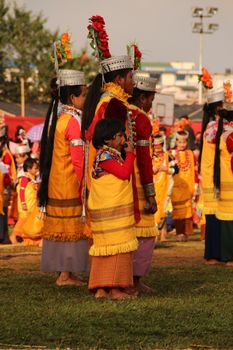 Group of people in colorful traditional attire at an outdoor festival showcasing cultural dances. - Fotografer Sidoarjo