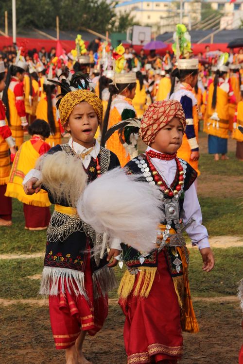 Free Young boys in traditional Indian attire performing at a cultural festival outdoors. Stock Photo