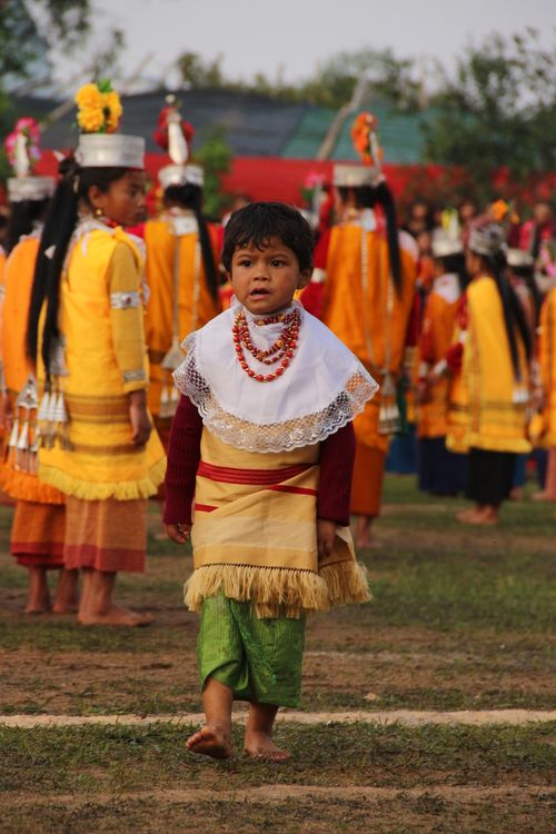 Free Child in traditional clothing at a colorful cultural festival, showcasing vivid traditional attire and local customs. Stock Photo