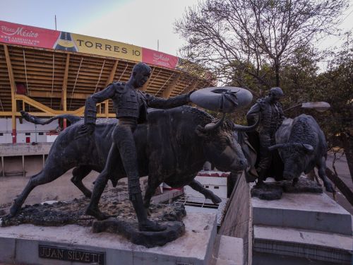 Free Sculptures of matadors and bulls outside a prominent Mexico City stadium, showcasing historic art. Stock Photo