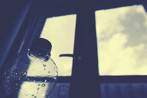 Clear Plastic Bottle Beside Window