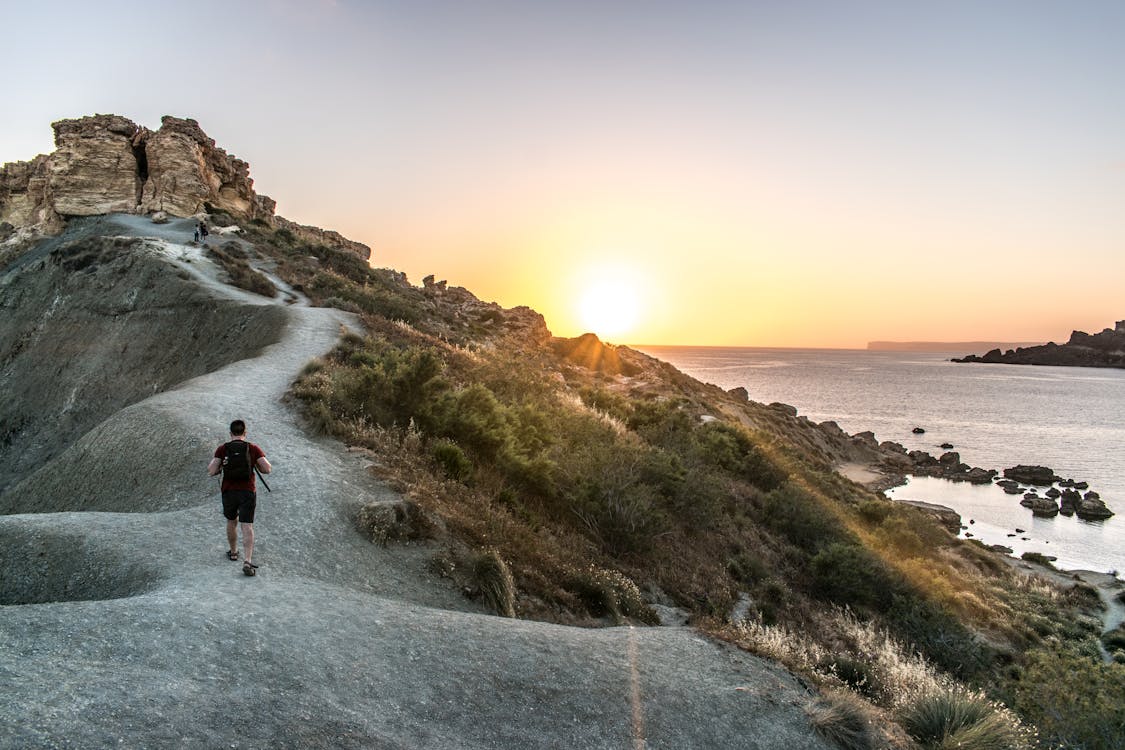 A Man Walking on Mountain Cliff