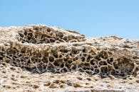 Brown and Black Rock Formation Under Blue Sky