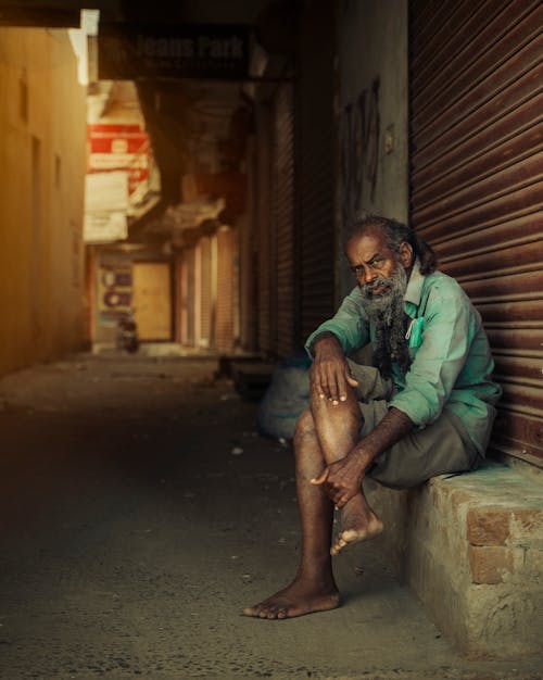 Kostnadsfri bild av äldre man, barfota, betong