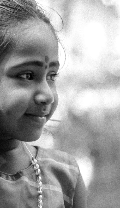 Grayscale Photo of a Smiling Girl