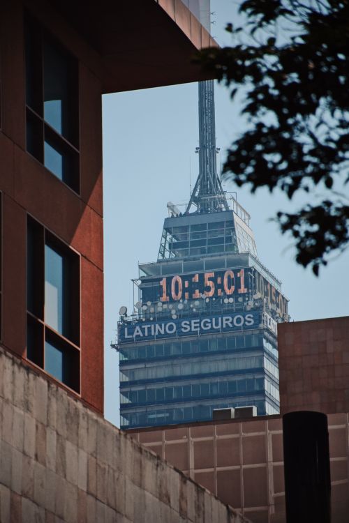 Free View of the Torre Latinoamericana framed by modern architecture in Mexico City. Stock Photo