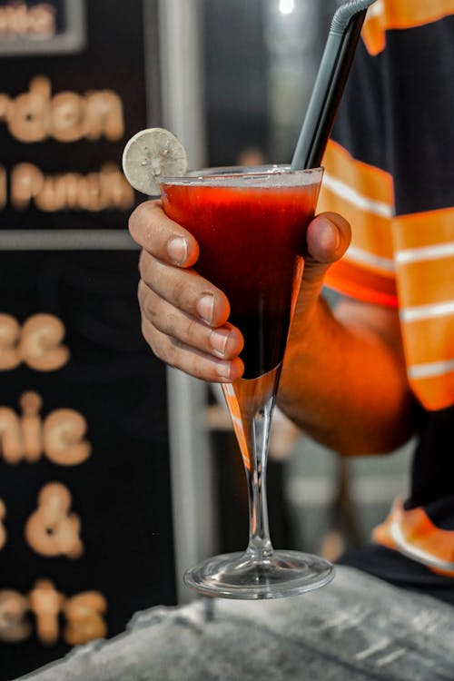 Person Holding Bloody Mary Cocktail Drink