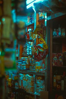 Vibrant interior of a small shop with diverse snacks and goods on shelves.