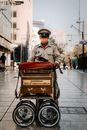 An Organ Grinder with His Barrel Organ in a Cart