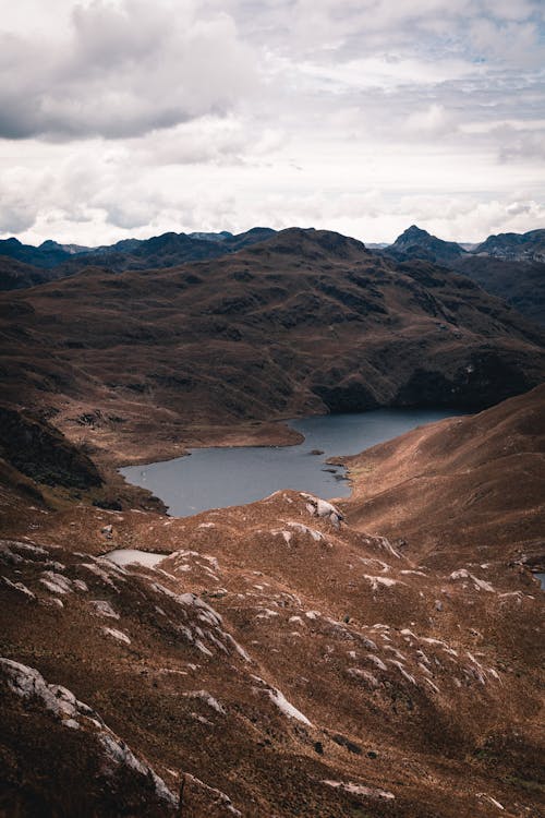 Free Cloudy Sky over Mountains and a Lake Stock Photo