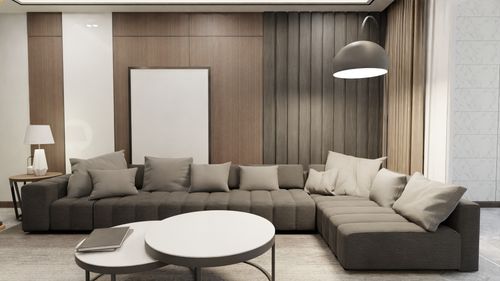 Free Stylish minimalist living room featuring modern furniture and soft lighting. Stock Photo