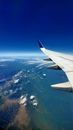 White Airplane Wing over the Clouds