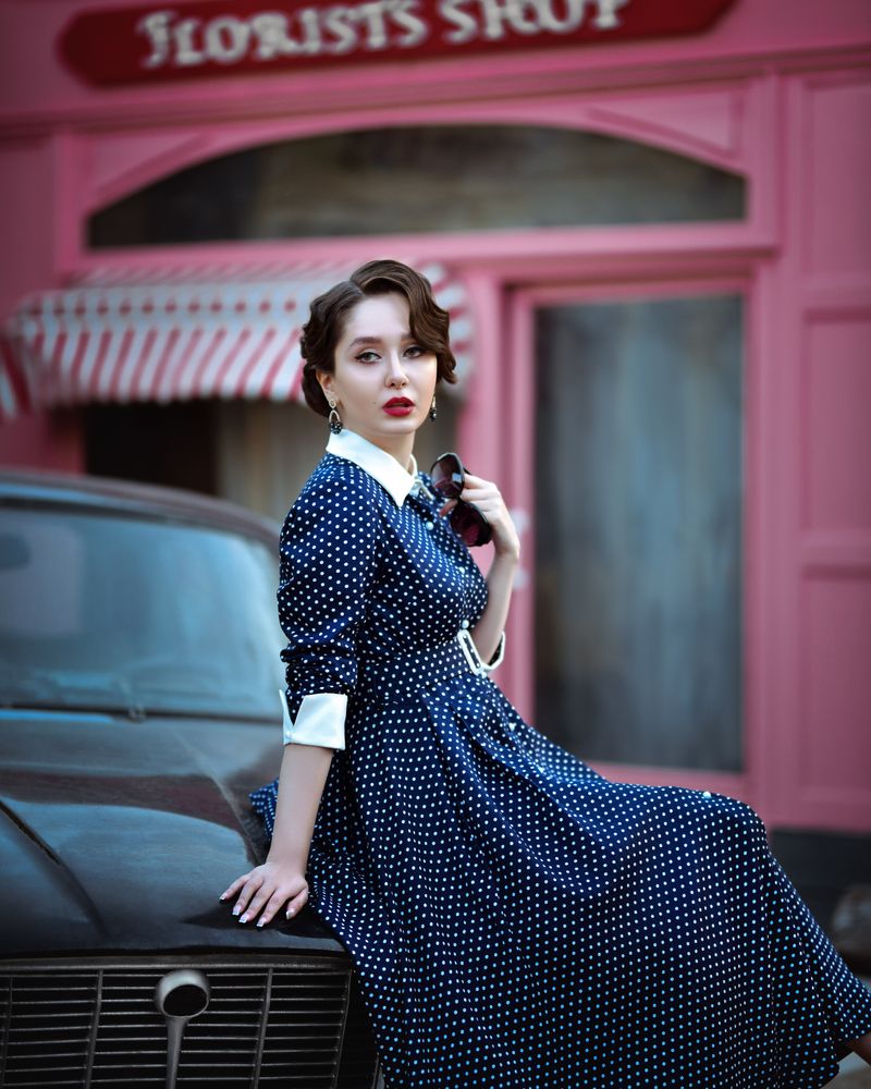 woman wearing a blue polka dot midi dress