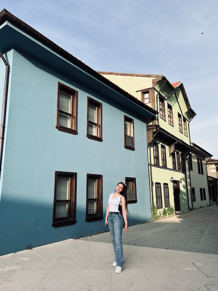 A Woman Standing Outside The House