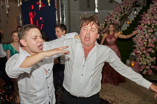 Free Men in White Dress Shirts Dancing at a Party Stock Photo