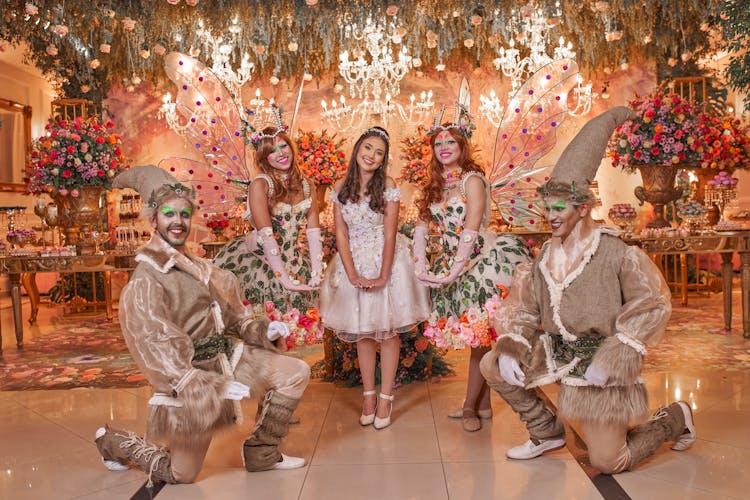 Young Woman Posing With People In Costumes At A Party 