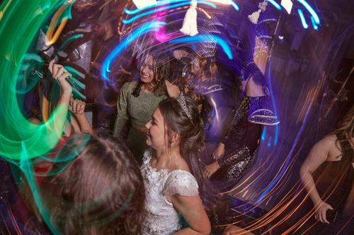 Free Teenagers dance in colorful lights at a lively birthday celebration. Stock Photo