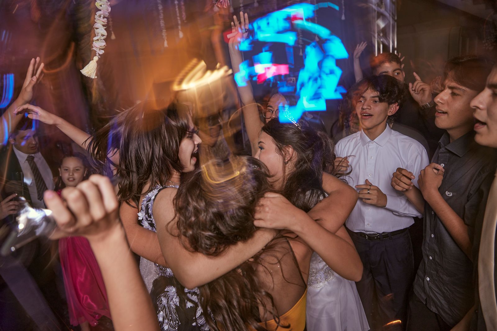 Teenagers dancing energetically together in a group setting
