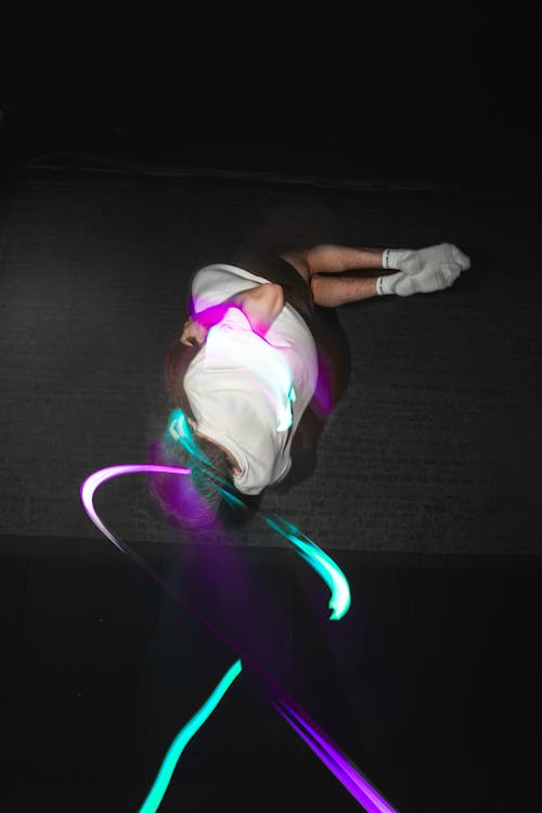 Free Man Jumping Making Colorful Light Composition Stock Photo