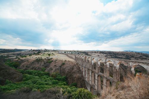 Free Breathtaking view of the historic Arcos del Sitio aqueduct stretching across Mexico's countryside. Stock Photo