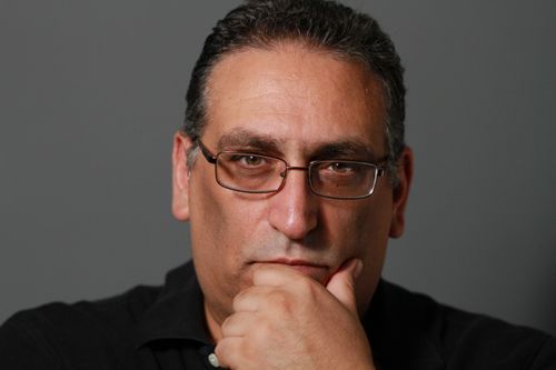 Free Close-up portrait of a middle-aged man in glasses thinking deeply. Stock Photo