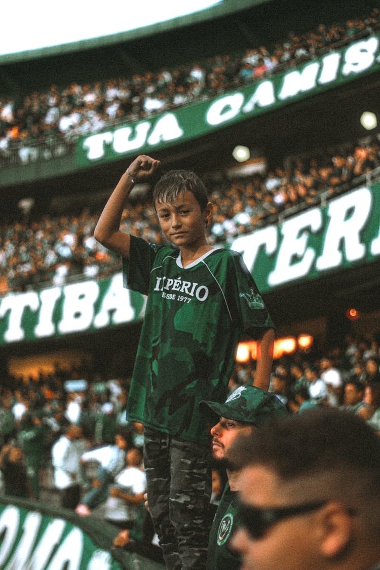 A Boy Standing In A Stadium