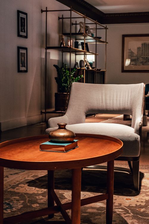 Free Sophisticated and cozy living room with an elegant armchair and round table enhancing the decor. Stock Photo
