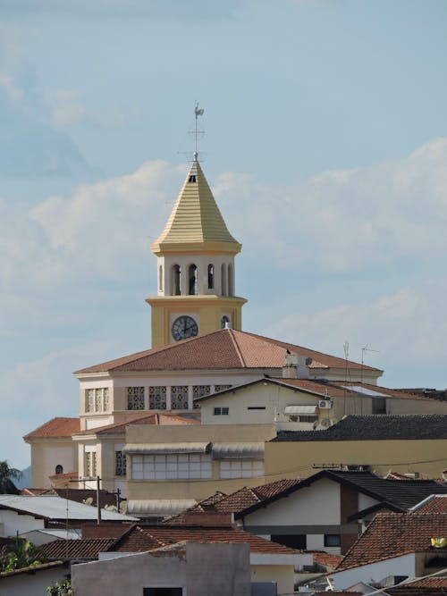 Church Bell Tower Behind Houses Photo
