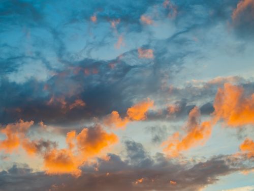 Free A stunning sunset sky filled with vibrant clouds in contrasting colors. Stock Photo