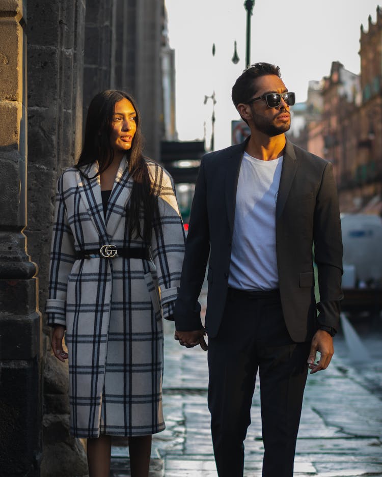 Stylish Couple Walking On Sidewalk