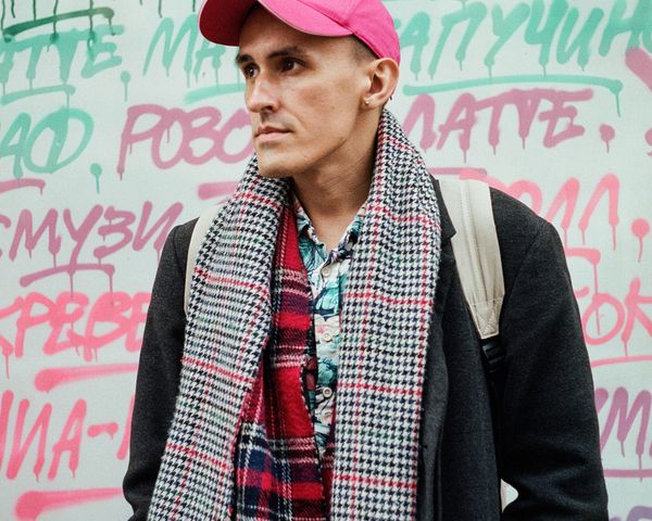 Man wearing plaid tartan scarf and cap winter fashion