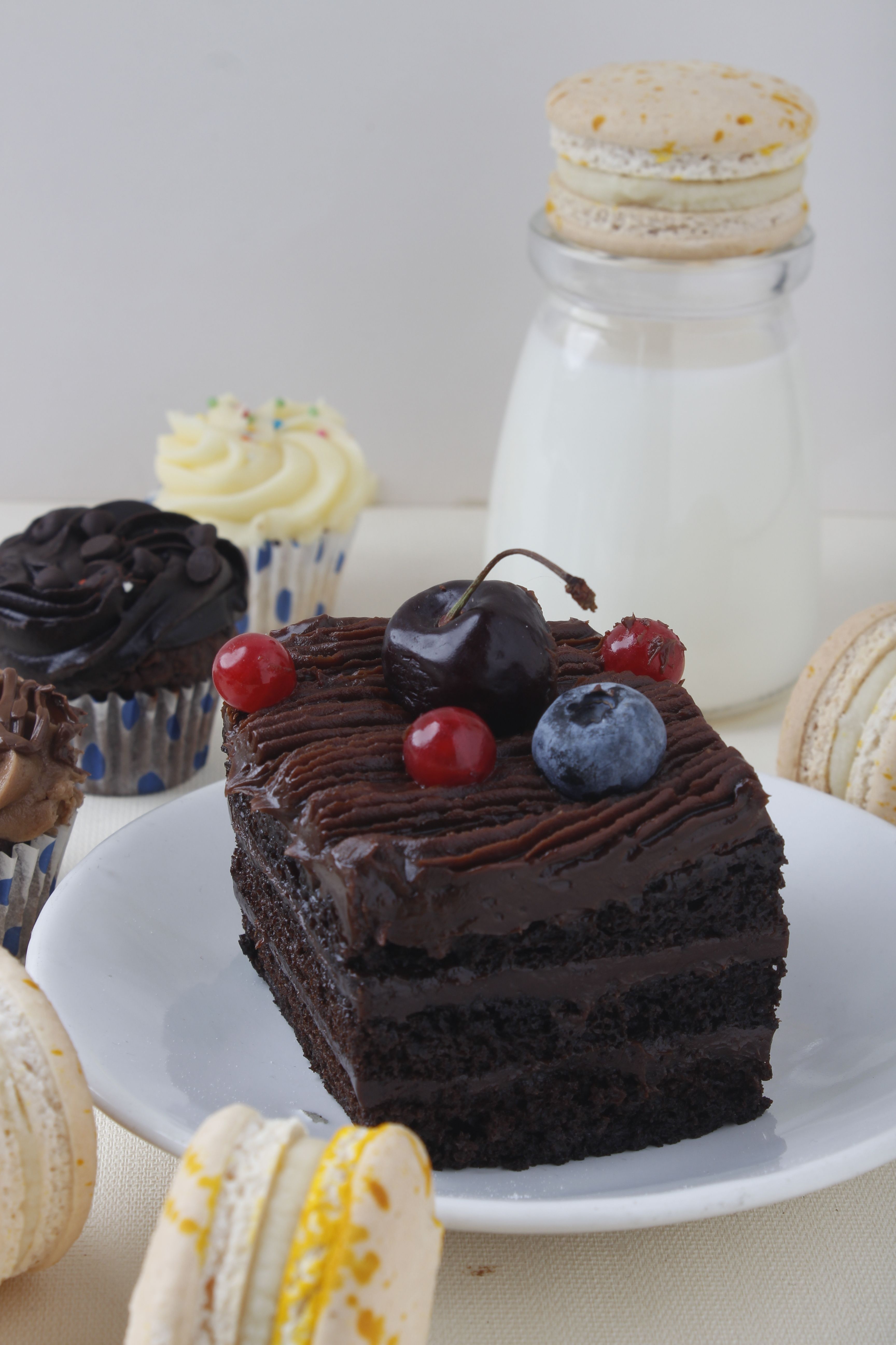 A Slice of Chocolate Cake Fruit Topping on White Plate · Free Stock Photo