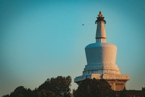 Free Iconic White Dagoba in Beihai Park, Beijing against a clear blue sky. Stock Photo