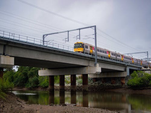 Passenger Train on a Bridge above a River 