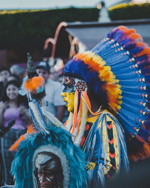 Person Wearing a Tribal Costume and Face Painting Dancing on Street Parade