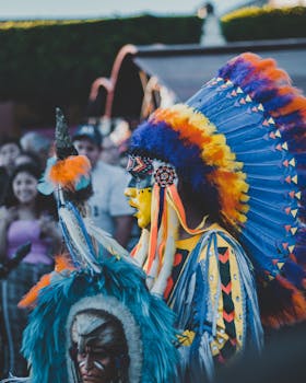 Vibrant cultural celebration with people in traditional costumes at an outdoor festival in Santiago de Querétaro, Mexico.