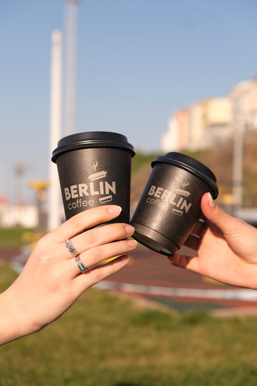 People Holding  Hot Coffee in a Disposable Cups