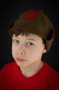 A Boy in Red Shirt and Brown Cap