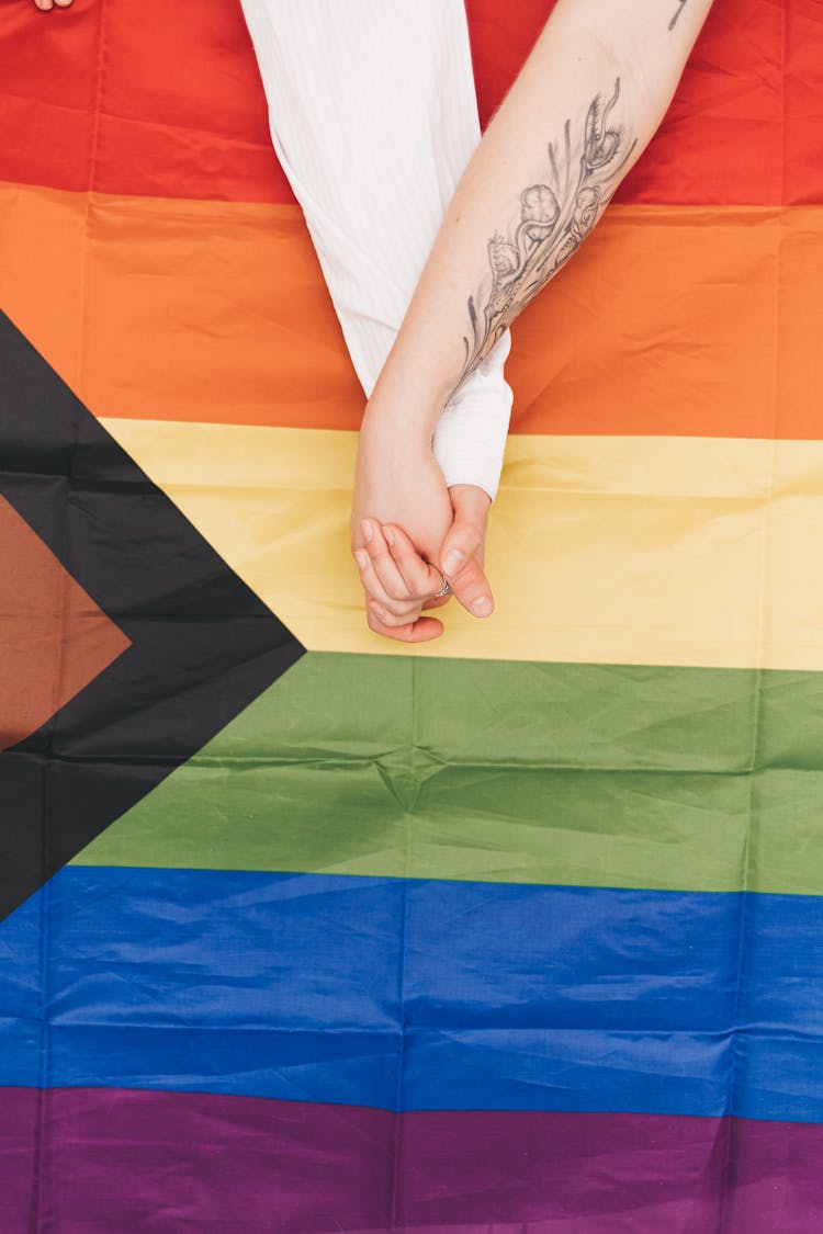 Clasped Hands Against Progress Pride Flag