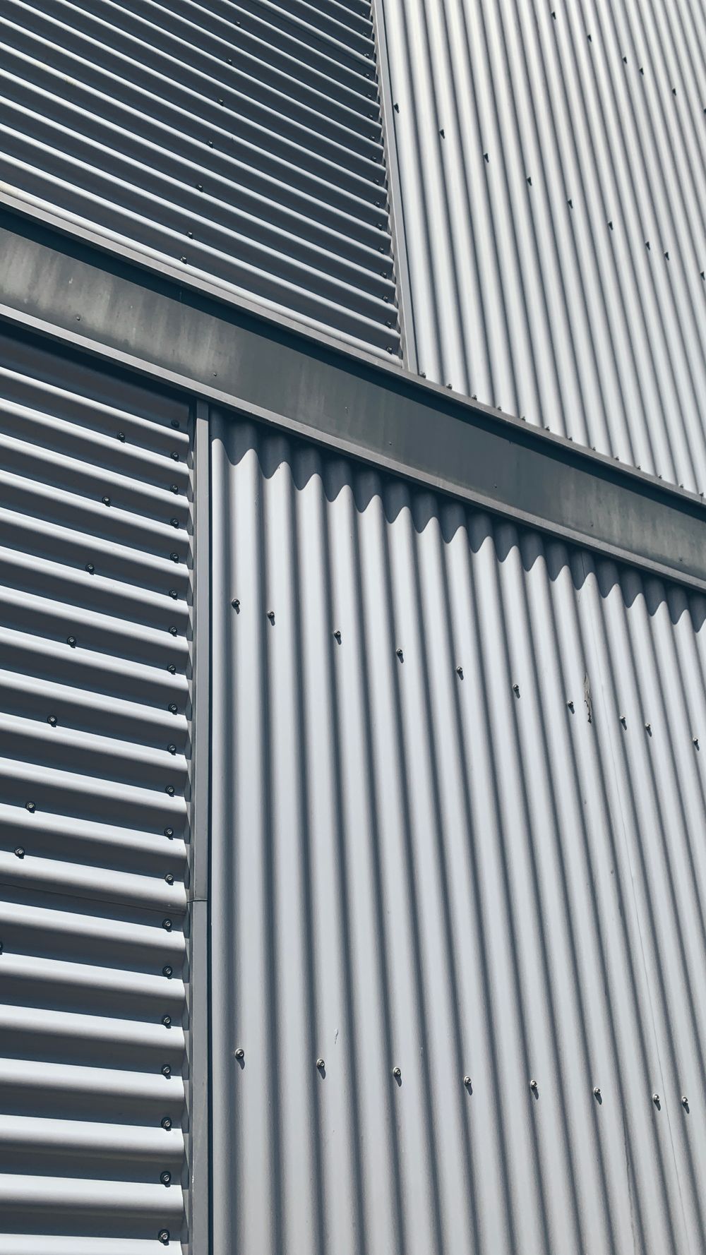 Corrugated galvanized steel sheets on a building façade, shown as a reference photograph