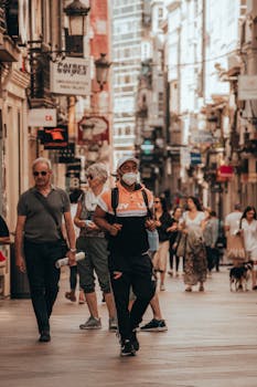 People walking down a busy A Coruña street, capturing urban life and travel spirit.
