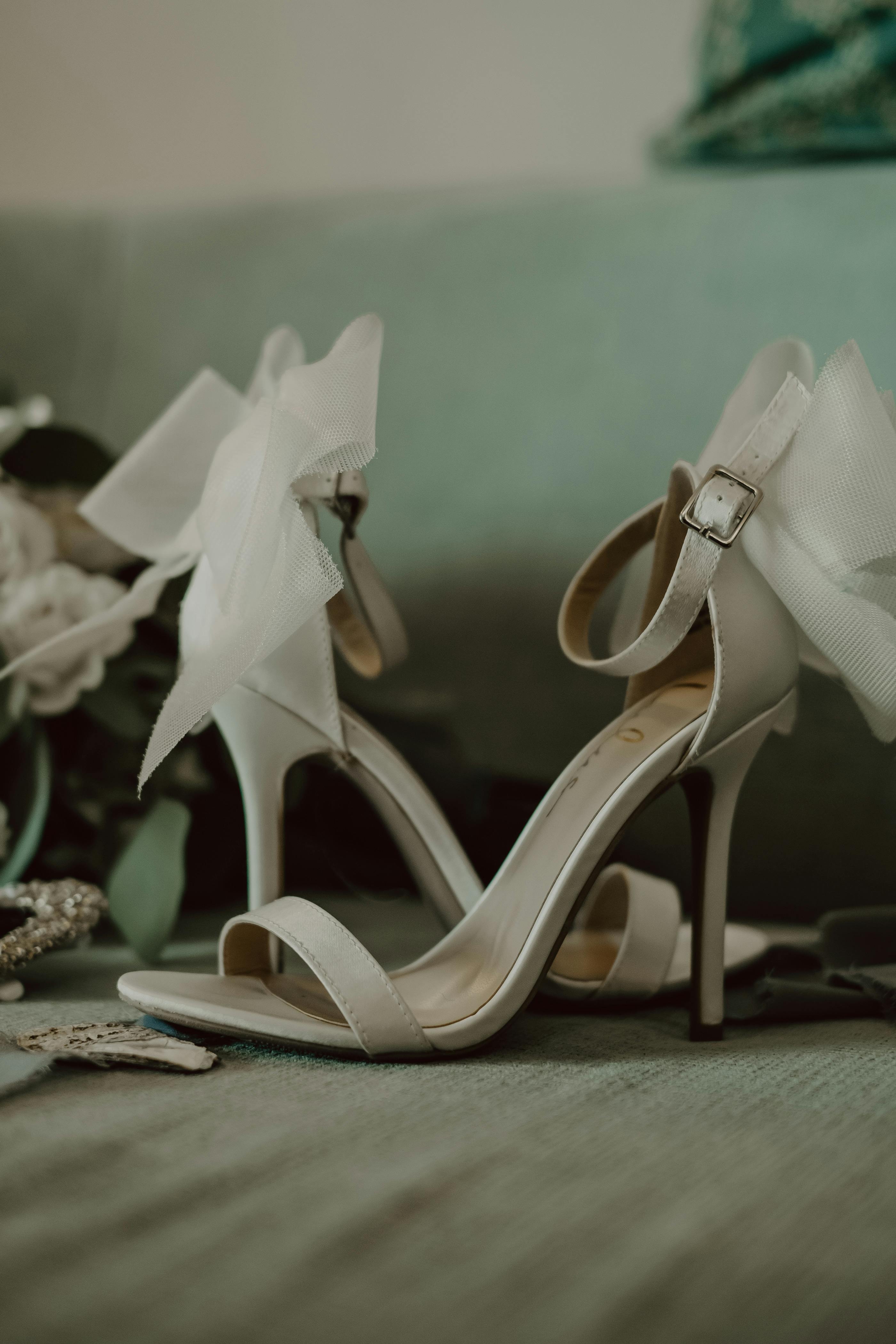 Wedding Rings and Flowers on Wedding Invitation Near High Heeled Shoes ...