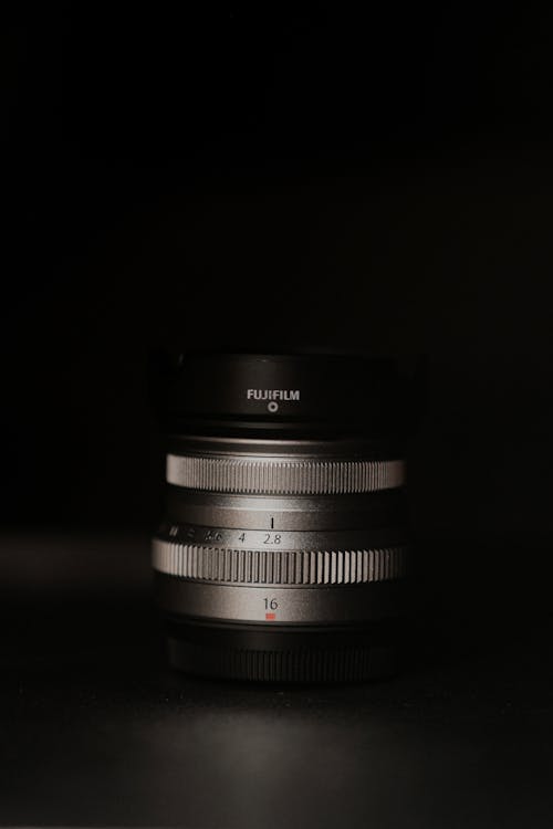 Close-Up Shot of a Camera Lens on Black Surface