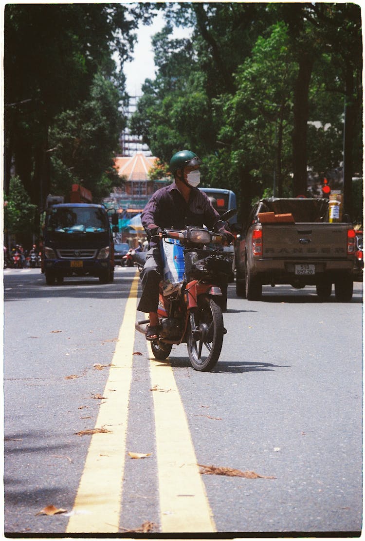 A Man Driving A Motorcycle